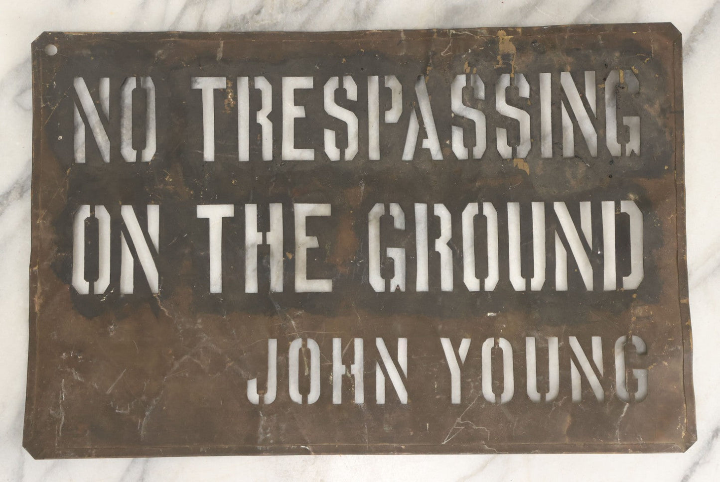Lot 204 - Antique Brass Stencil Reading “No Trespassing On The Ground — John Young”