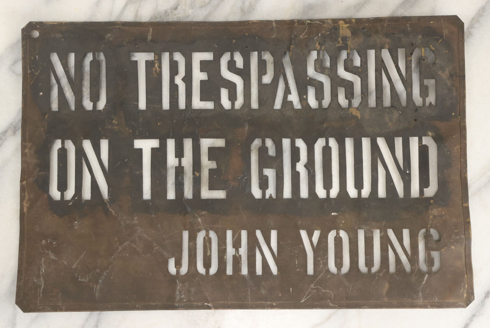 Lot 204 - Antique Brass Stencil Reading “No Trespassing On The Ground — John Young”