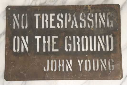 Lot 204 - Antique Brass Stencil Reading “No Trespassing On The Ground — John Young”