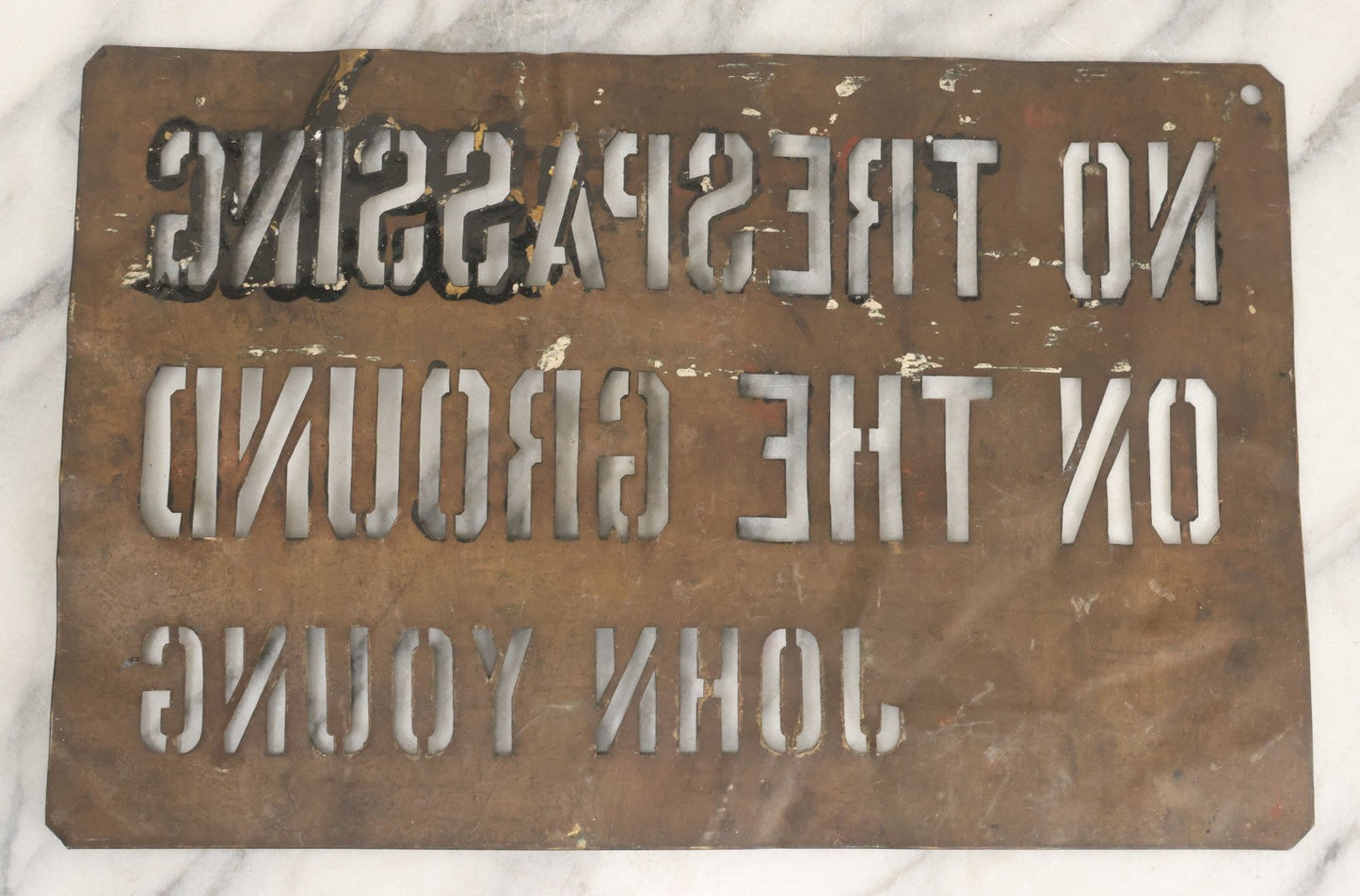 Lot 204 - Antique Brass Stencil Reading “No Trespassing On The Ground — John Young”