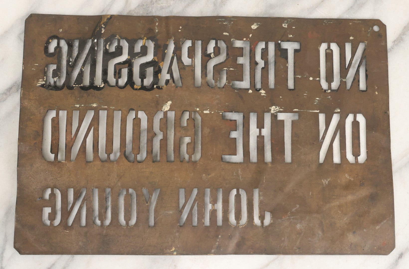 Lot 204 - Antique Brass Stencil Reading “No Trespassing On The Ground — John Young”