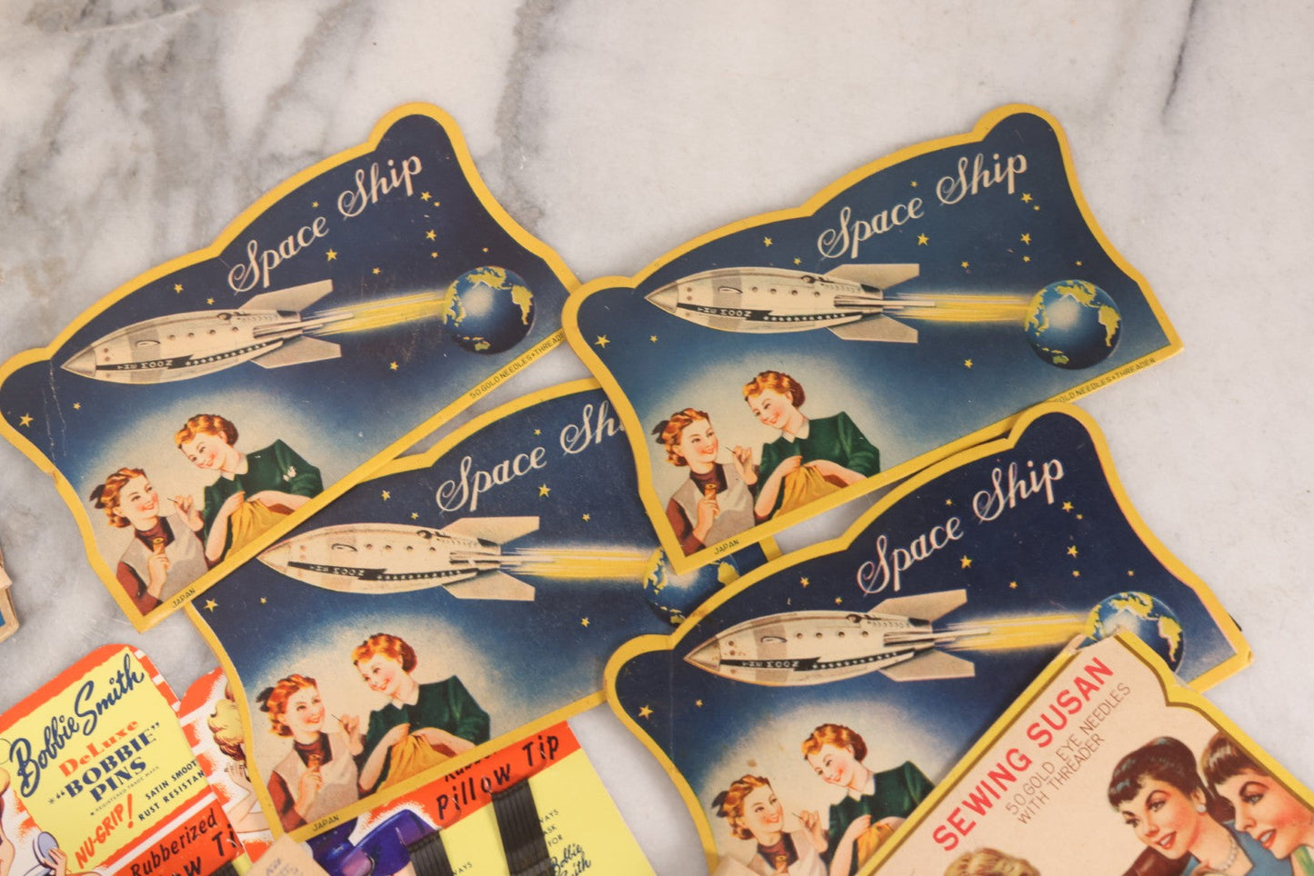 Lot 212 - Vintage Grouping Of 20+ Sewing Needle & Notions Card Lot Including Space Ship & Rocket Brand Needle Folders, Bobbie Smith Bobbie Pins, And Other Vintage Sewing Cards