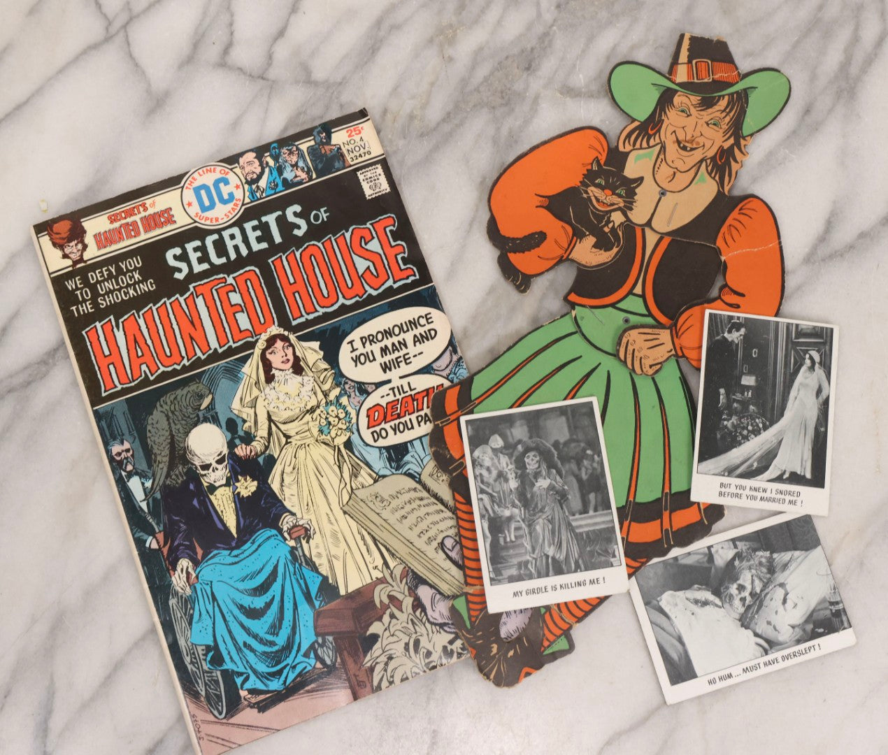 Lot 235 - Grouping Of Five Pieces Of Spooky Ephemera Including Jointed Die-Cut Halloween Witch Decoration, DC “Secrets Of Haunted House” Comic, And Topps Creature Feature Horror Trading Cards