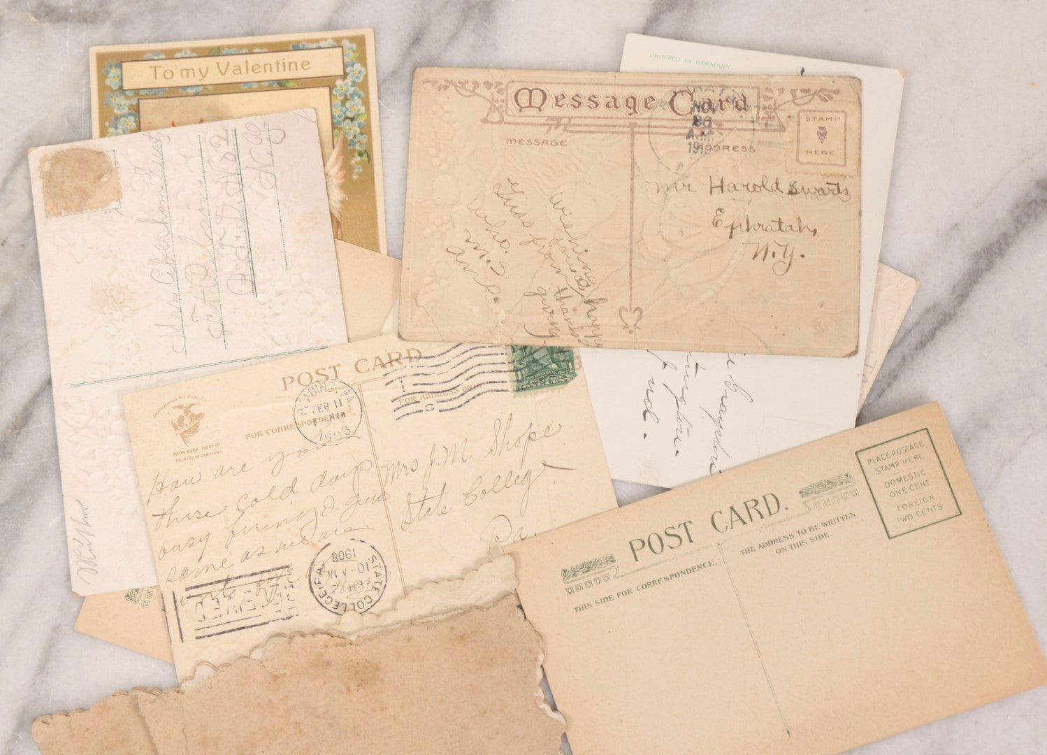 Lot 236 - Grouping Of Nine Antique Valentine And Holiday Postcards, Including One With Real Hair Applied, Paper Lace, Gilt Accents, And Thanksgiving Card Depicting Jack-O-Lantern J.O.L. Carving