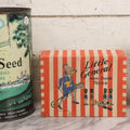 Lot 262 - Trio Of Vintage And Antique Advertising Pieces Including Grass Seed Tin, Camel Tire Tube Repair Kit, And “Little General Infants Durable Hose” Undergarments Box, W.T. Grant Co., 1923