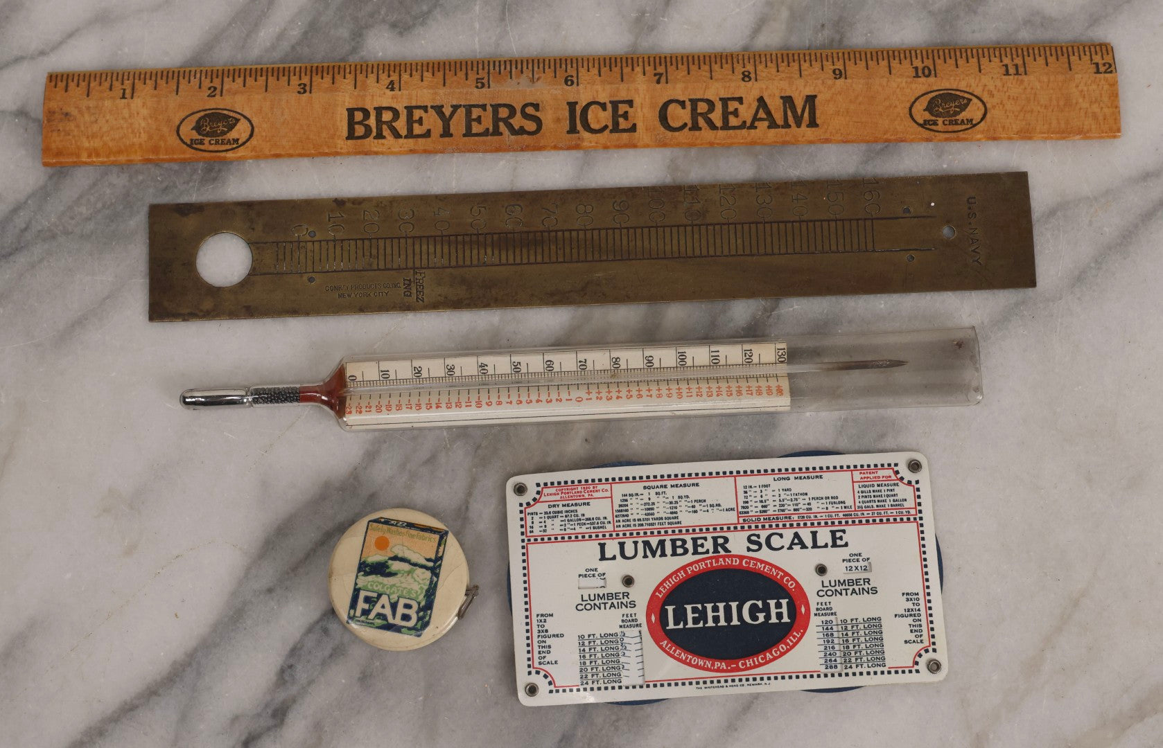 Lot 271 - Grouping Of Five Vintage Advertising Rulers, Thermometers, And Measuring Tools Including Breyers Ice Cream, Lehigh Portland Cement Co., Colgate's Fab, Railway Signal Association, And Conray Products Co. Inc. Navy Thermometer Fragment