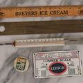 Lot 271 - Grouping Of Five Vintage Advertising Rulers, Thermometers, And Measuring Tools Including Breyers Ice Cream, Lehigh Portland Cement Co., Colgate's Fab, Railway Signal Association, And Conray Products Co. Inc. Navy Thermometer Fragment