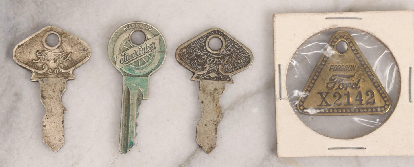 Lot 274 - Grouping Of 13 Vintage Advertising And Metal Pieces Including Ford And Studebaker Keys, Sutter's Hi Speed Turtle Bottle Opener, Acme Thunderer Whistles, S.S. Kresge Co. Feeler Gauge, And Shell Service Scraper