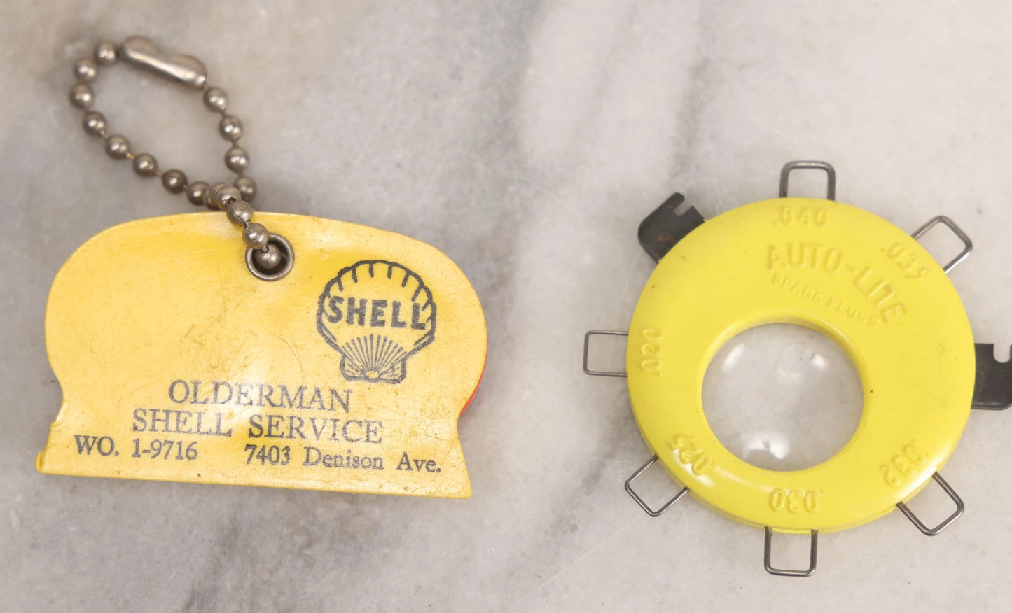 Lot 274 - Grouping Of 13 Vintage Advertising And Metal Pieces Including Ford And Studebaker Keys, Sutter's Hi Speed Turtle Bottle Opener, Acme Thunderer Whistles, S.S. Kresge Co. Feeler Gauge, And Shell Service Scraper