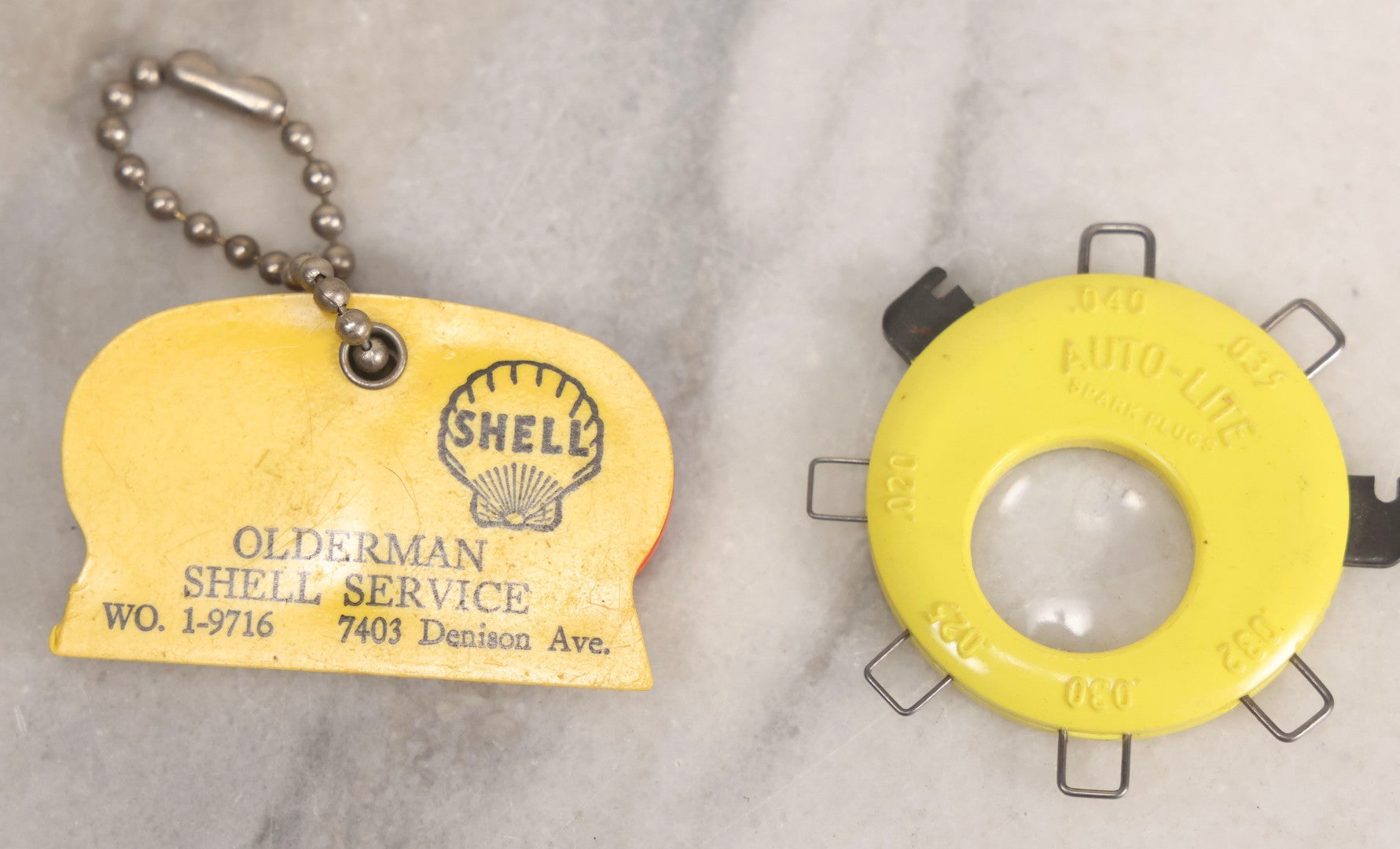 Lot 274 - Grouping Of 13 Vintage Advertising And Metal Pieces Including Ford And Studebaker Keys, Sutter's Hi Speed Turtle Bottle Opener, Acme Thunderer Whistles, S.S. Kresge Co. Feeler Gauge, And Shell Service Scraper