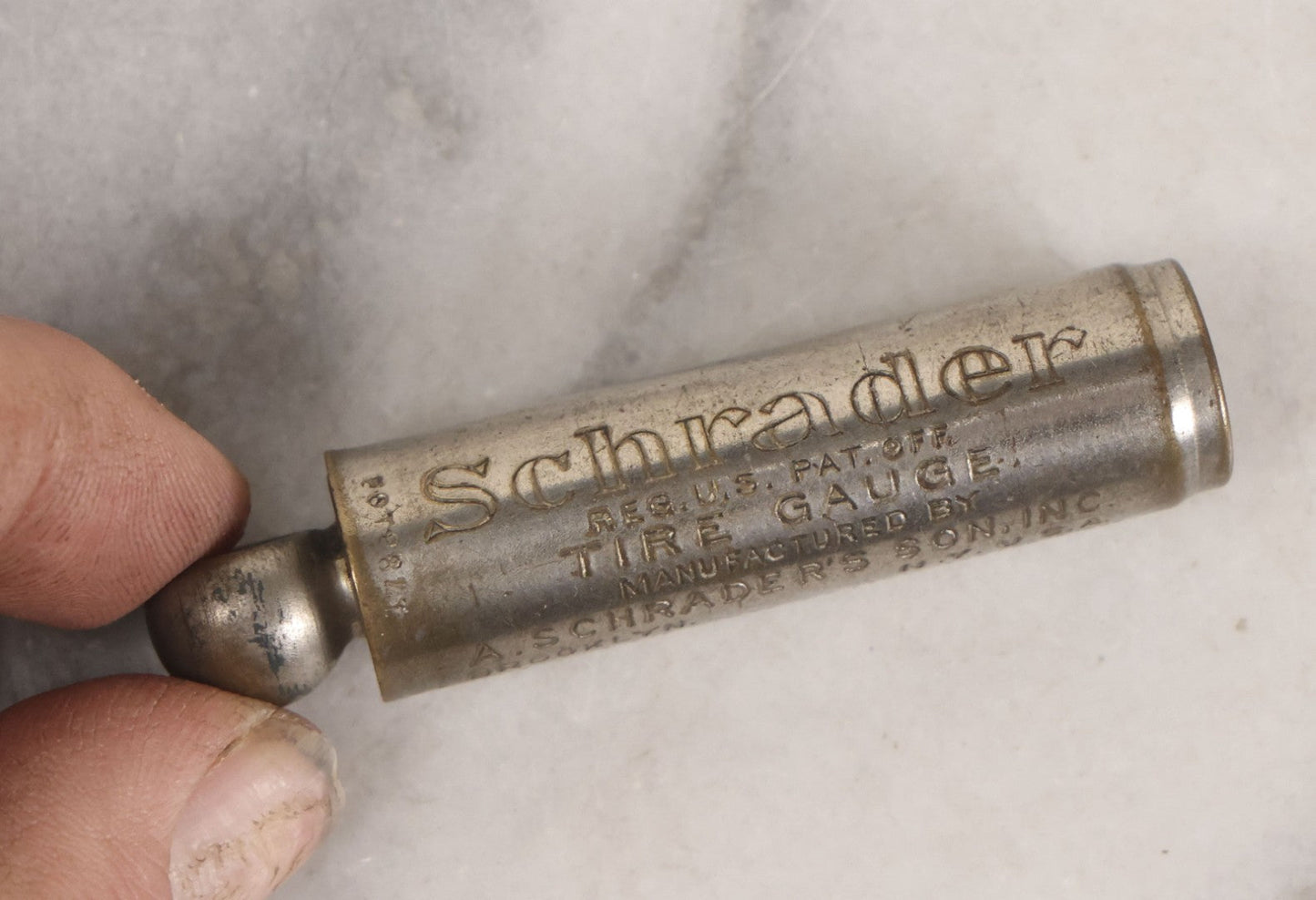 Lot 275 - Grouping Of Six Vintage Metal Objects Including Fire King Aluminum Rose Garden Marker, Cast Iron Meat Tenderizer, Schrader Tire Pressure Gauge, Lucky Dime Register Bank, Esterbrook Clip, And Mechanics Pal Tape Measure