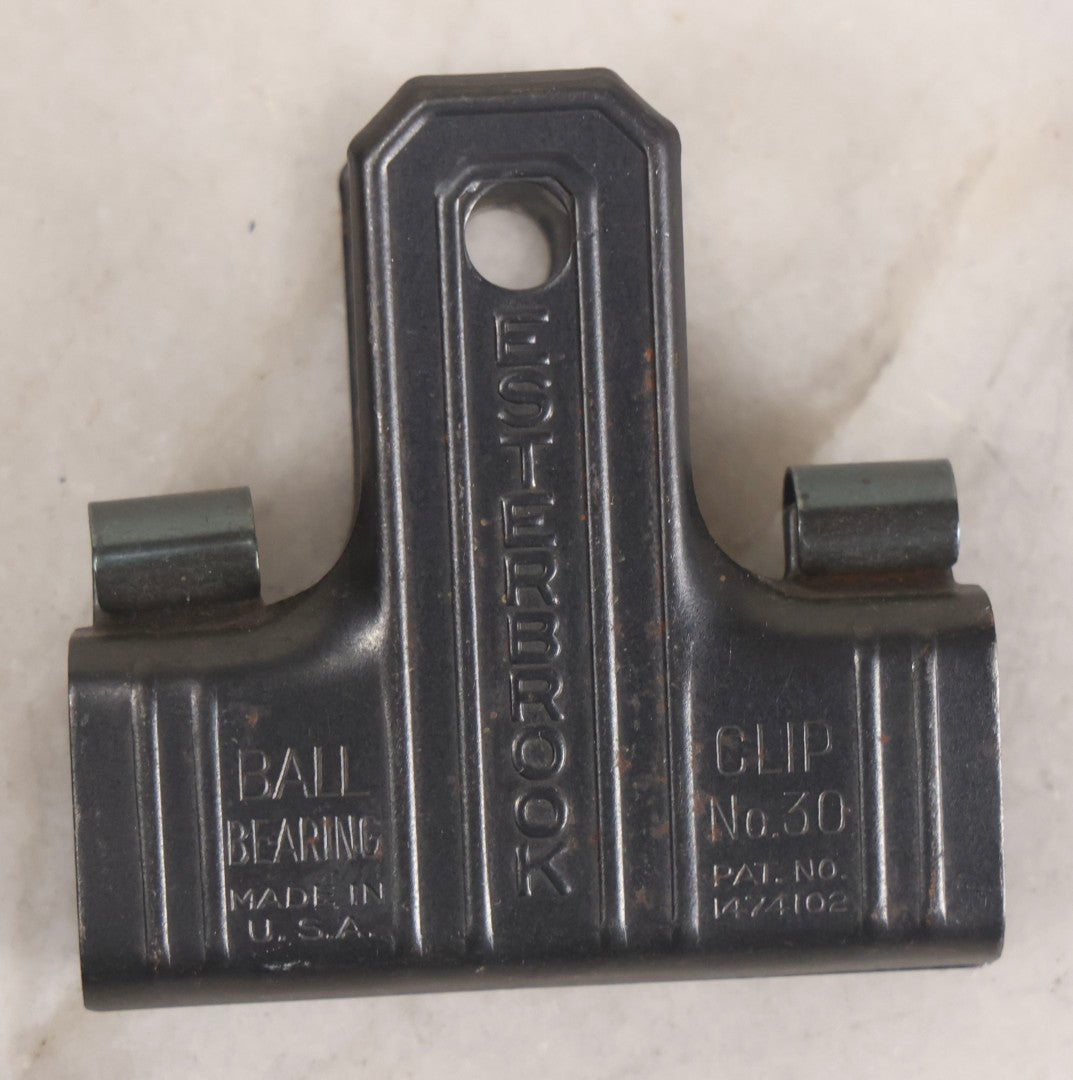 Lot 275 - Grouping Of Six Vintage Metal Objects Including Fire King Aluminum Rose Garden Marker, Cast Iron Meat Tenderizer, Schrader Tire Pressure Gauge, Lucky Dime Register Bank, Esterbrook Clip, And Mechanics Pal Tape Measure