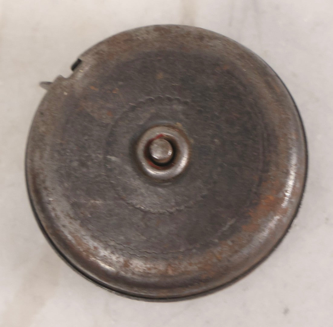 Lot 275 - Grouping Of Six Vintage Metal Objects Including Fire King Aluminum Rose Garden Marker, Cast Iron Meat Tenderizer, Schrader Tire Pressure Gauge, Lucky Dime Register Bank, Esterbrook Clip, And Mechanics Pal Tape Measure