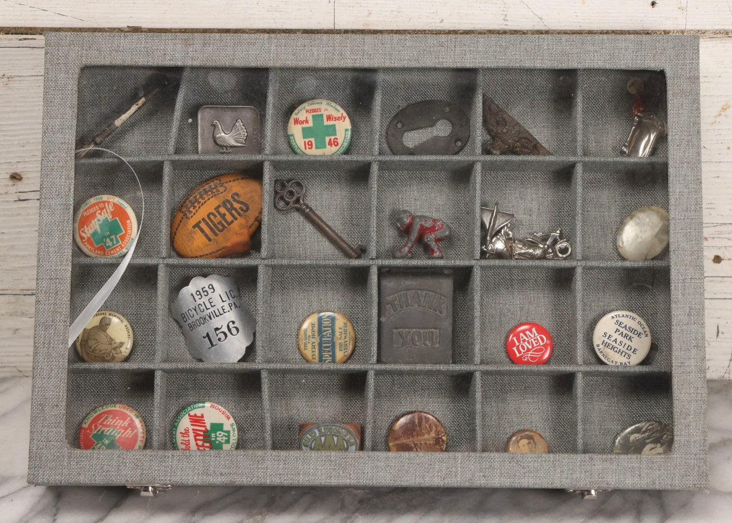 Lot 276 - Modern Display Case With Vintage Smalls And Advertising Pieces Including Candy Machine Door, Bicycle License, Pinback Buttons, Printing Block, And Metal Toy Football Player