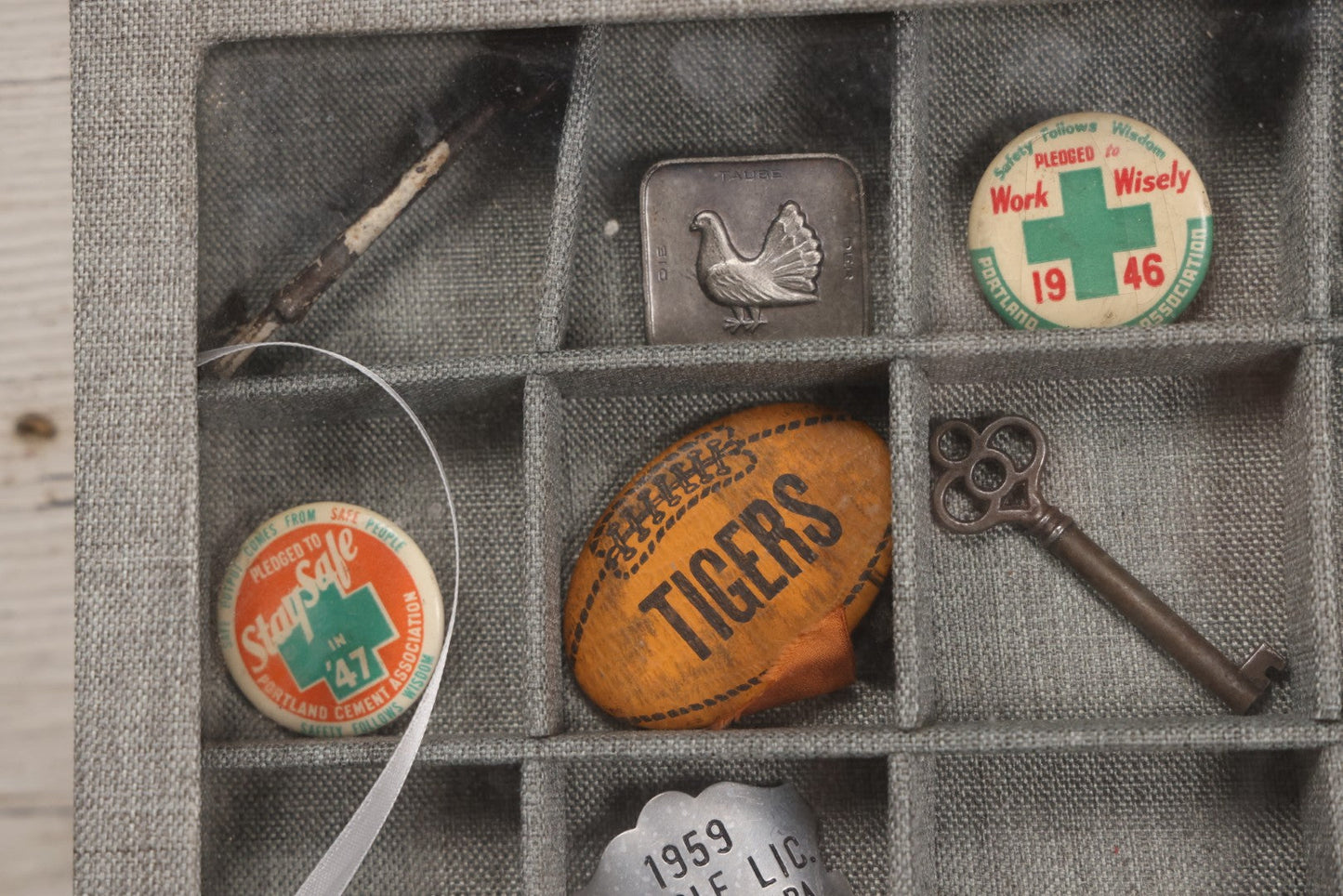 Lot 276 - Modern Display Case With Vintage Smalls And Advertising Pieces Including Candy Machine Door, Bicycle License, Pinback Buttons, Printing Block, And Metal Toy Football Player