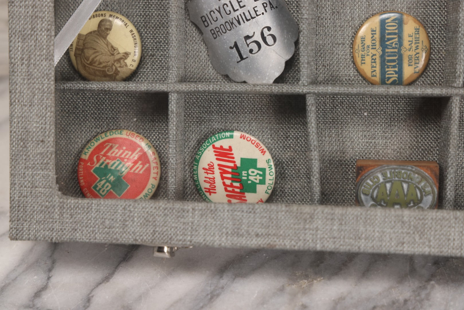 Lot 276 - Modern Display Case With Vintage Smalls And Advertising Pieces Including Candy Machine Door, Bicycle License, Pinback Buttons, Printing Block, And Metal Toy Football Player