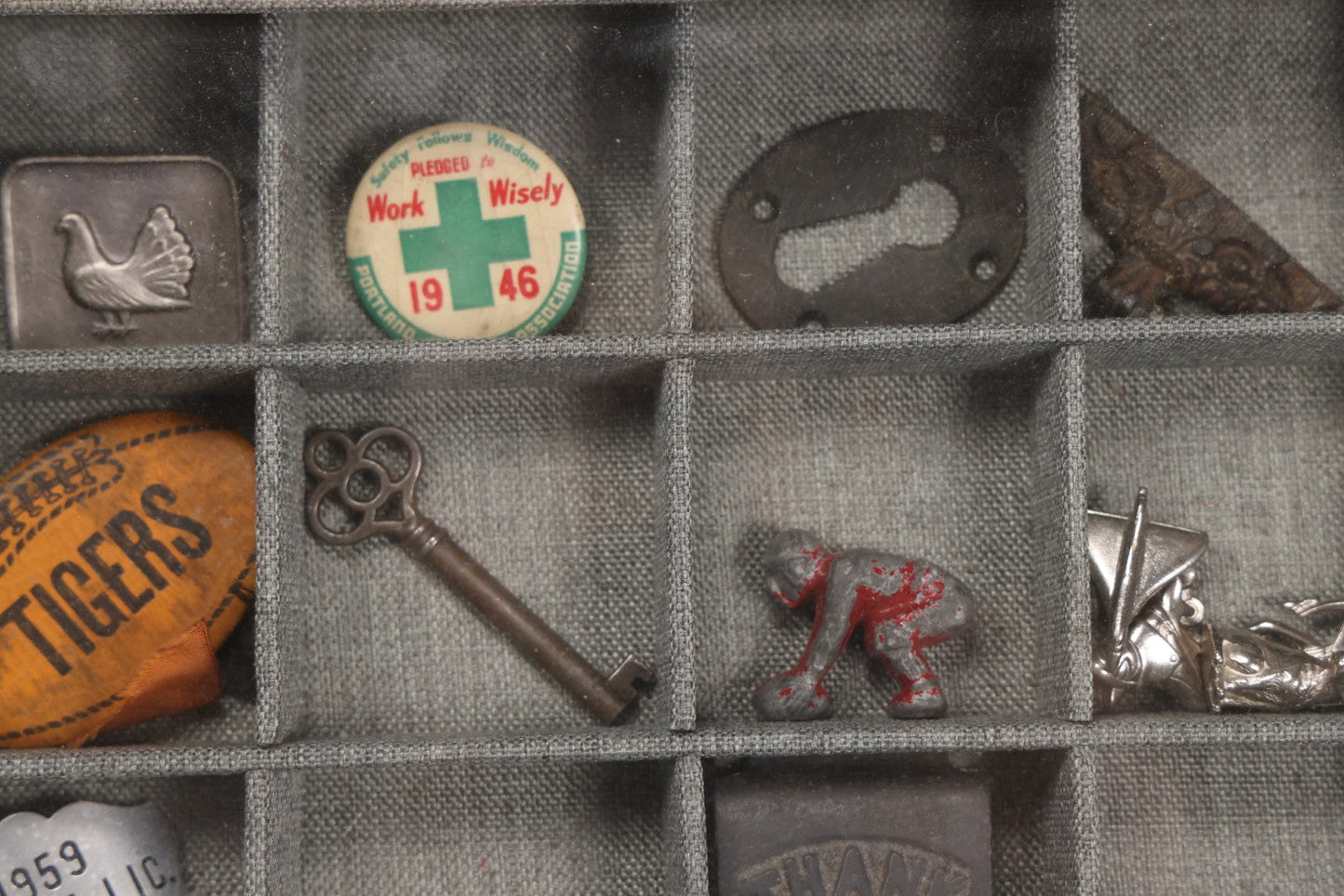 Lot 276 - Modern Display Case With Vintage Smalls And Advertising Pieces Including Candy Machine Door, Bicycle License, Pinback Buttons, Printing Block, And Metal Toy Football Player