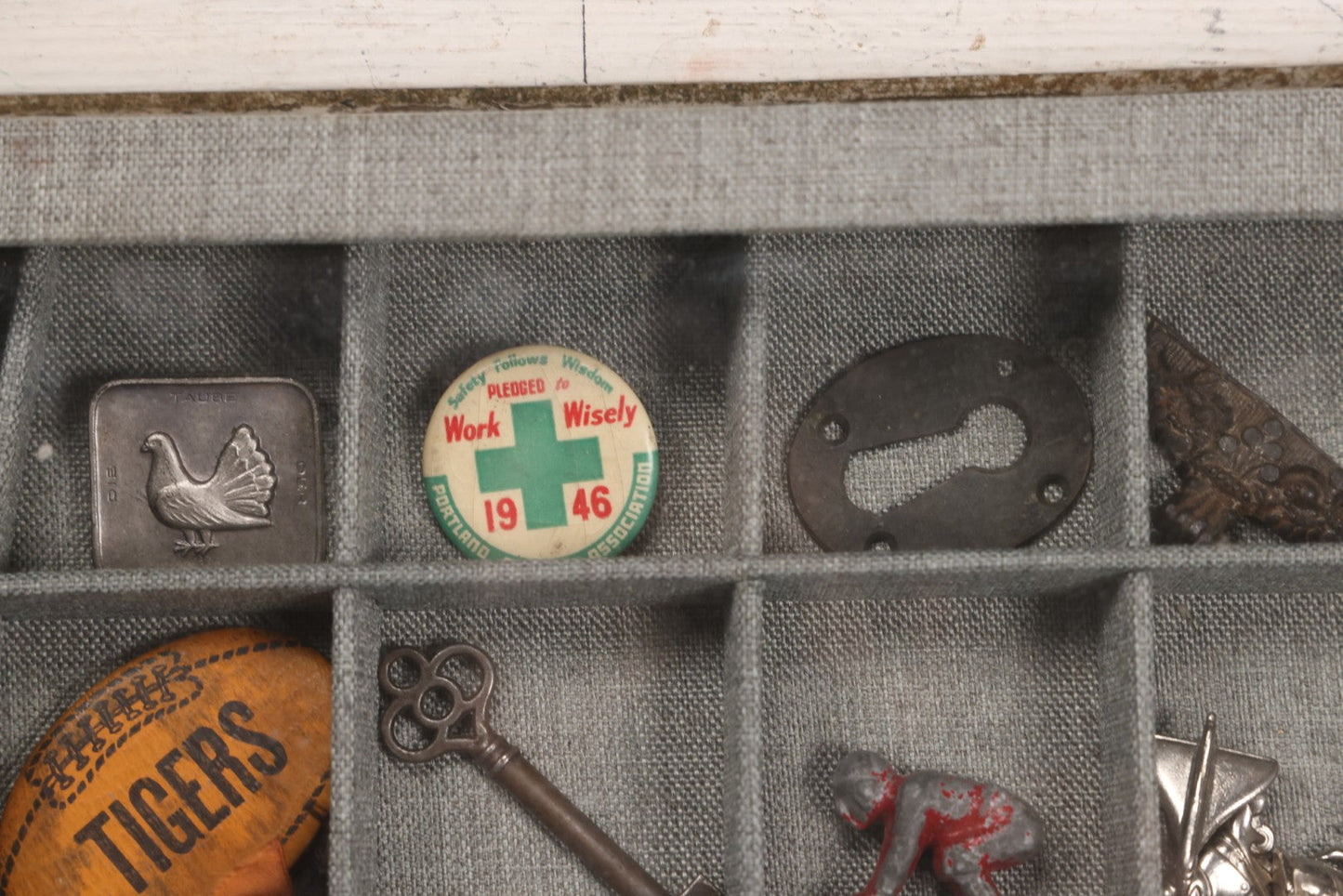Lot 276 - Modern Display Case With Vintage Smalls And Advertising Pieces Including Candy Machine Door, Bicycle License, Pinback Buttons, Printing Block, And Metal Toy Football Player