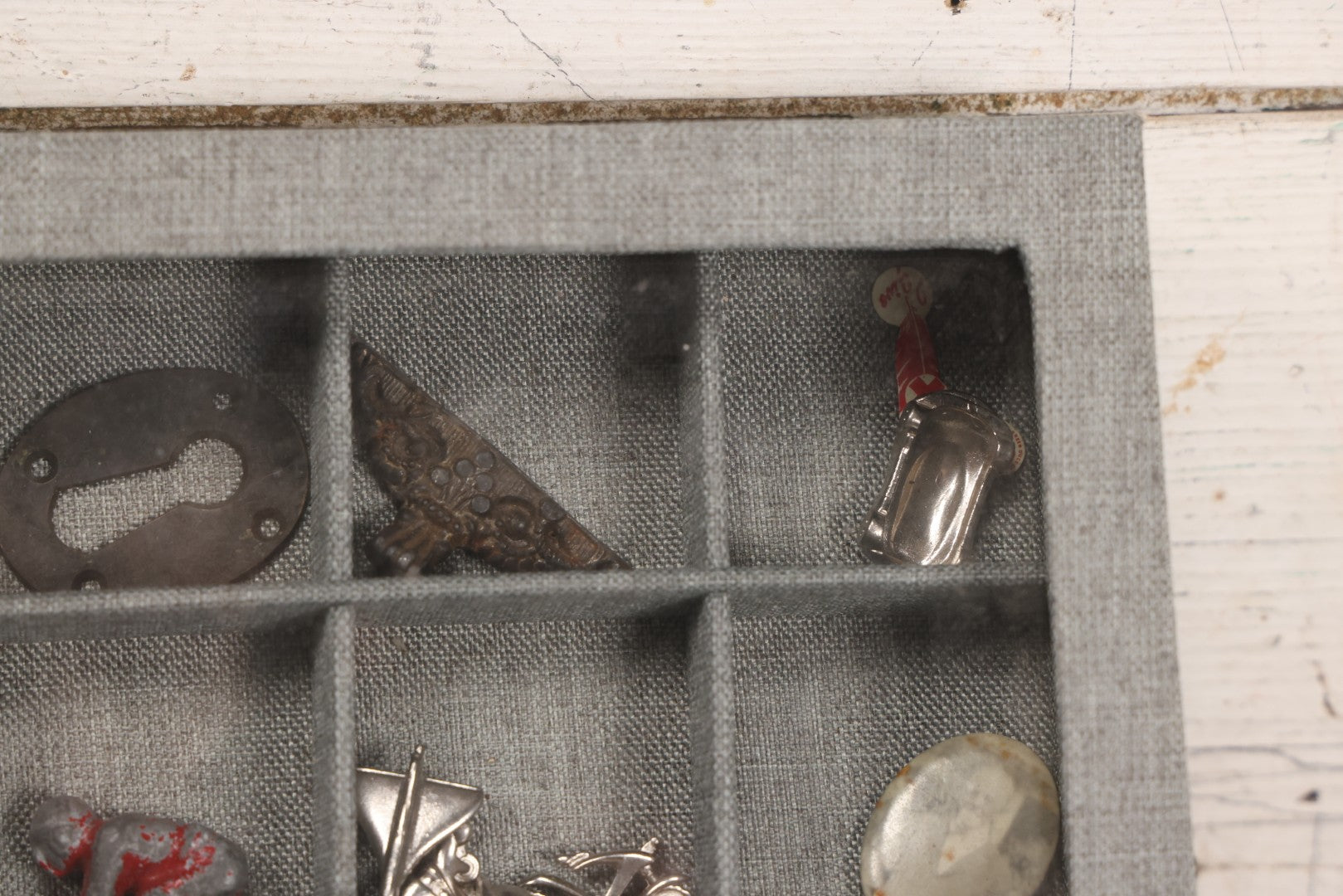 Lot 276 - Modern Display Case With Vintage Smalls And Advertising Pieces Including Candy Machine Door, Bicycle License, Pinback Buttons, Printing Block, And Metal Toy Football Player