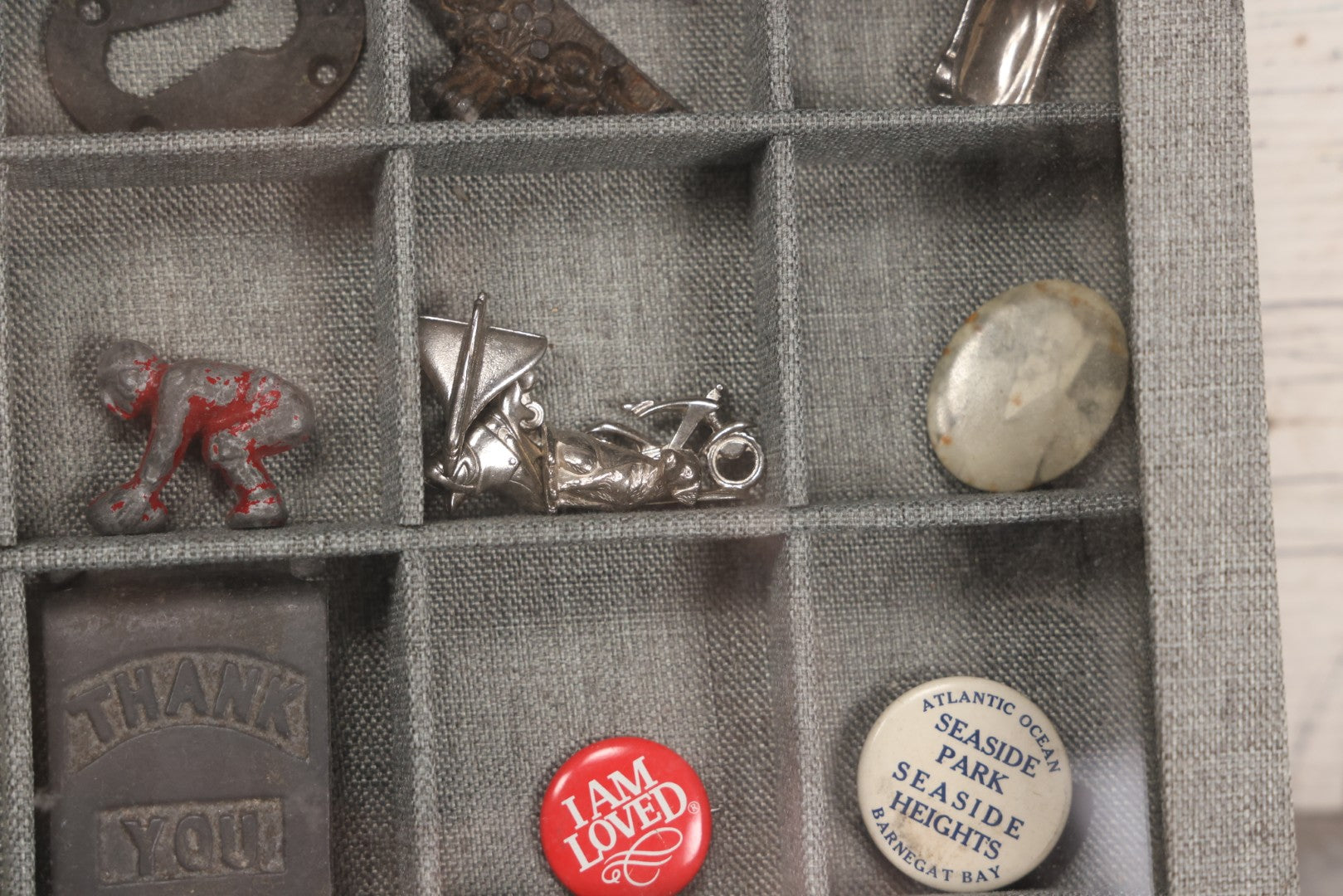 Lot 276 - Modern Display Case With Vintage Smalls And Advertising Pieces Including Candy Machine Door, Bicycle License, Pinback Buttons, Printing Block, And Metal Toy Football Player