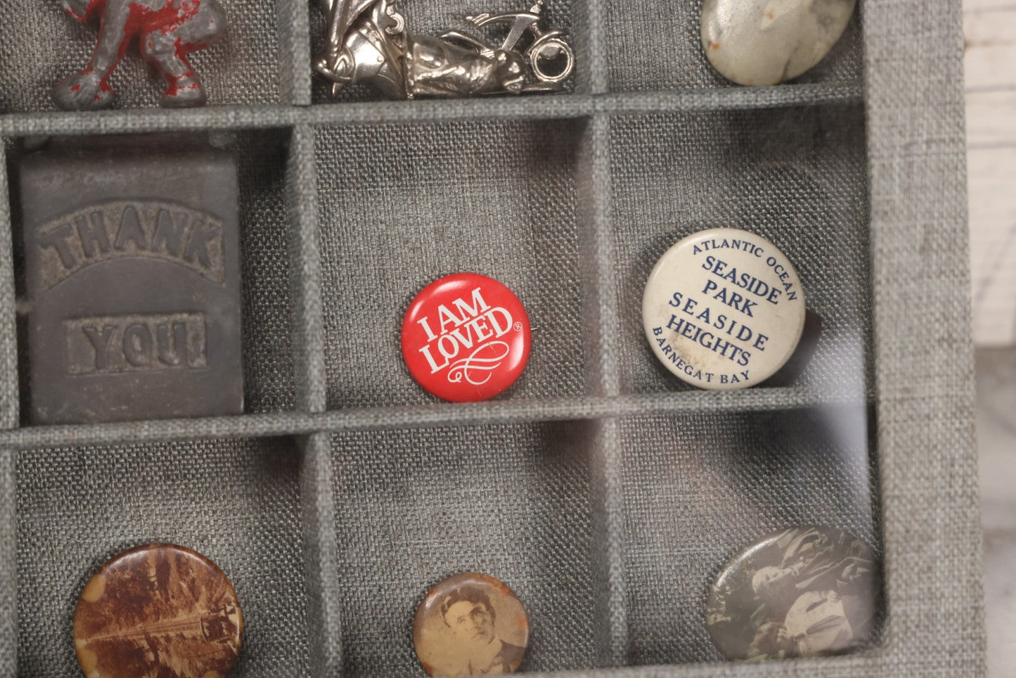 Lot 276 - Modern Display Case With Vintage Smalls And Advertising Pieces Including Candy Machine Door, Bicycle License, Pinback Buttons, Printing Block, And Metal Toy Football Player