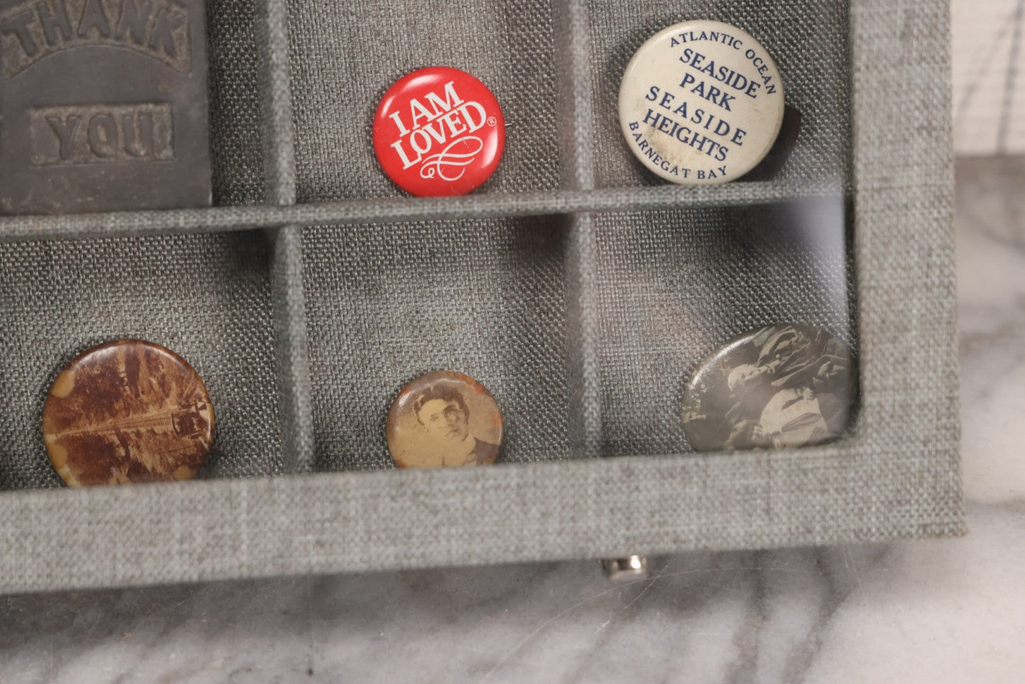 Lot 276 - Modern Display Case With Vintage Smalls And Advertising Pieces Including Candy Machine Door, Bicycle License, Pinback Buttons, Printing Block, And Metal Toy Football Player