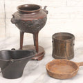 Lot 277 - Grouping Of Four Vintage Metal Vessels Including Bronze Smudge Pot, Brass Drum, Cast Iron Pan, And Ash Bucket With Scoop