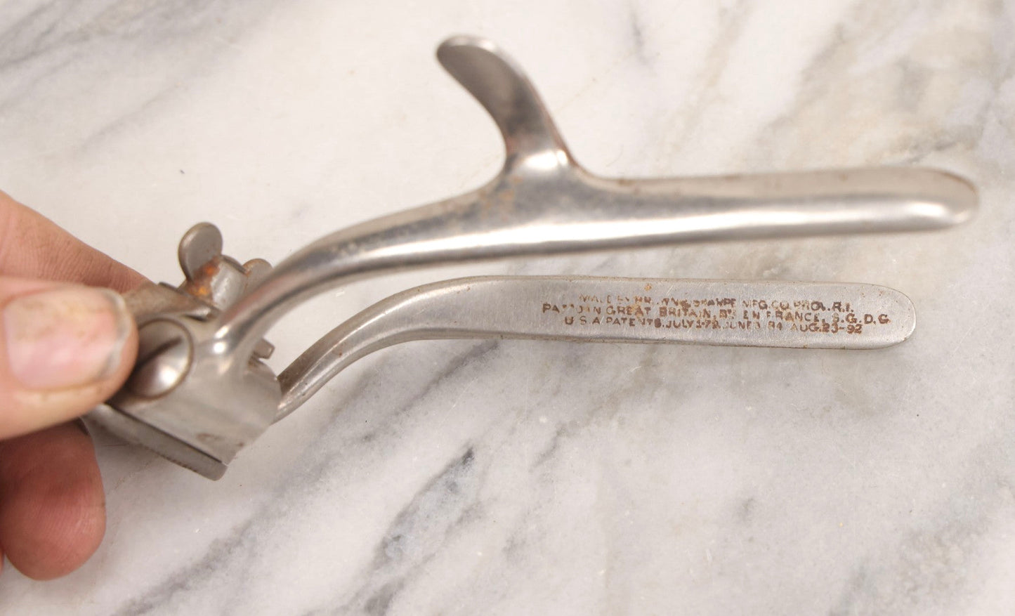 Lot 280 - Grouping Of Four Antique Shaving Items Including Gillette Metal Hot Water Bottle, Hand-Operated Clippers, And Stag Co. Razor Blade Sharpener