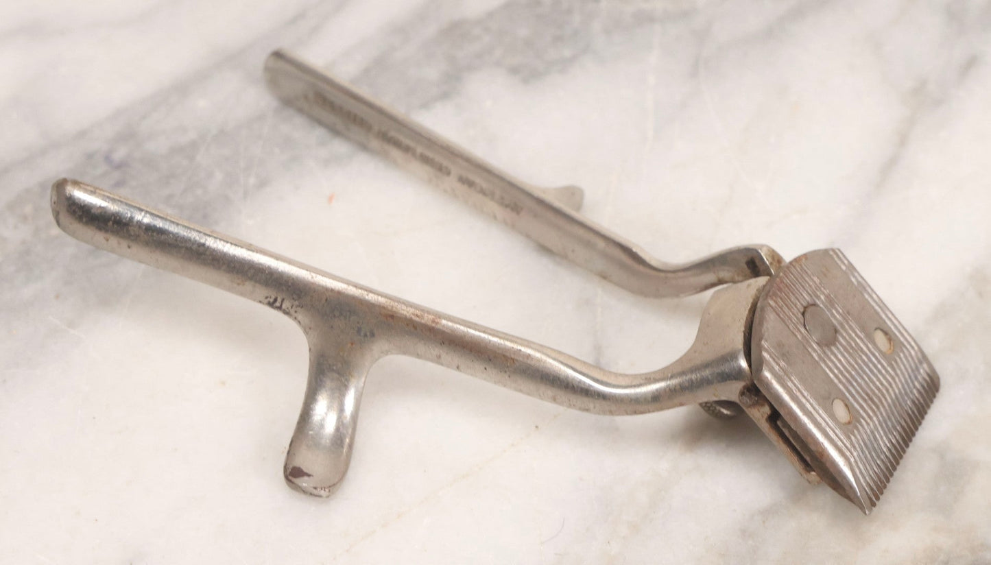 Lot 280 - Grouping Of Four Antique Shaving Items Including Gillette Metal Hot Water Bottle, Hand-Operated Clippers, And Stag Co. Razor Blade Sharpener