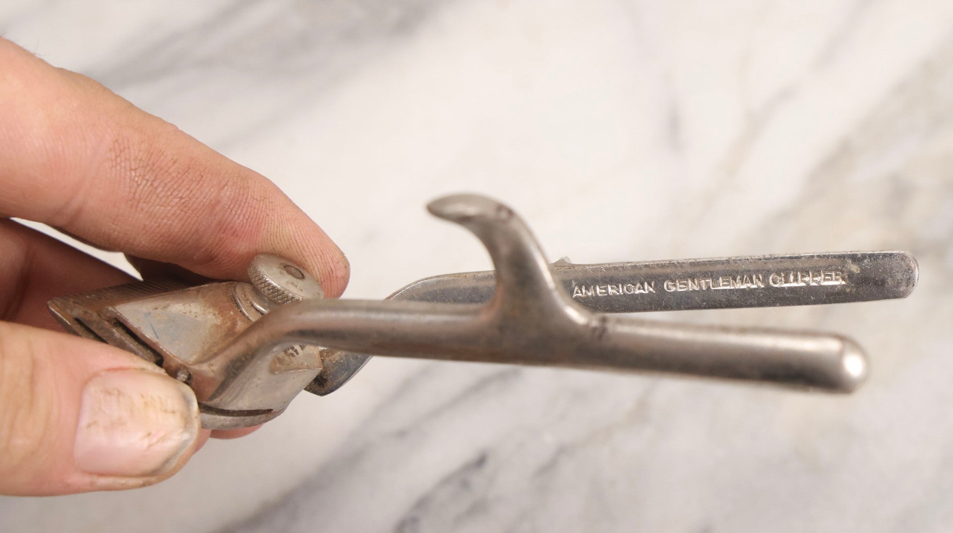 Lot 280 - Grouping Of Four Antique Shaving Items Including Gillette Metal Hot Water Bottle, Hand-Operated Clippers, And Stag Co. Razor Blade Sharpener