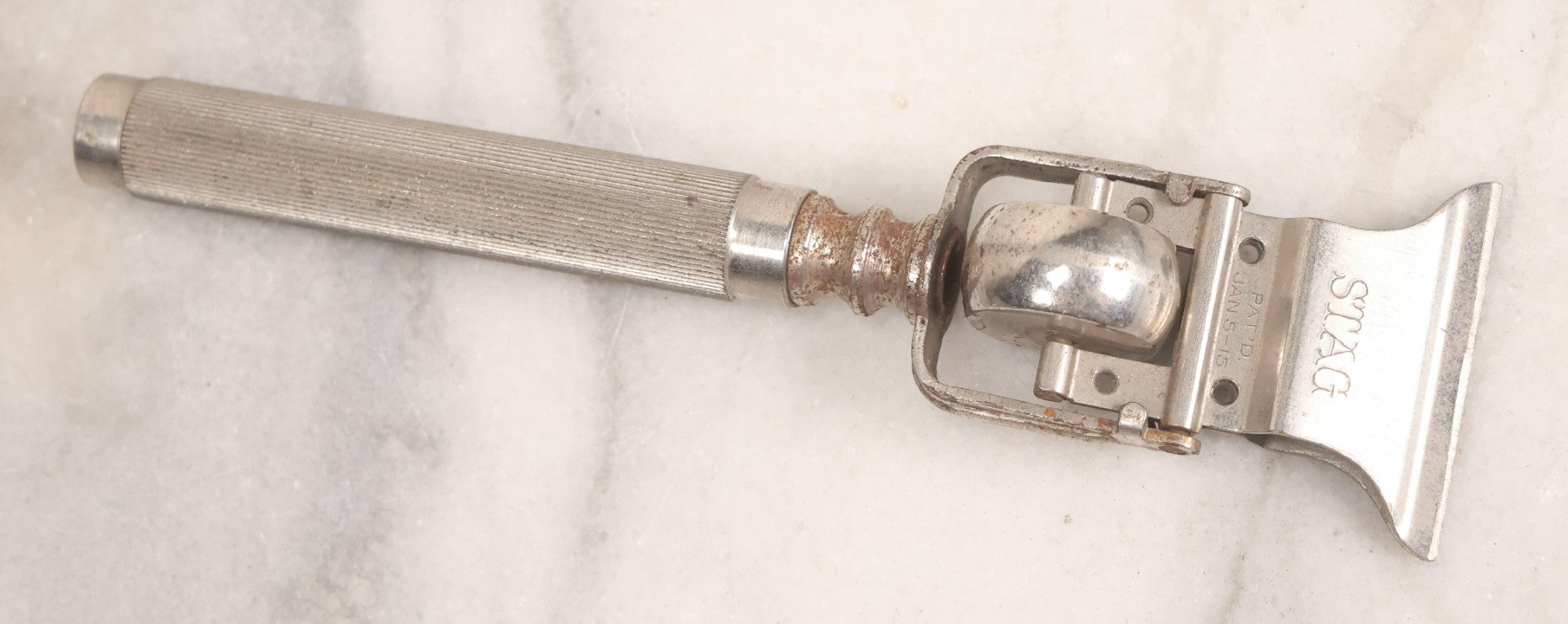 Lot 280 - Grouping Of Four Antique Shaving Items Including Gillette Metal Hot Water Bottle, Hand-Operated Clippers, And Stag Co. Razor Blade Sharpener