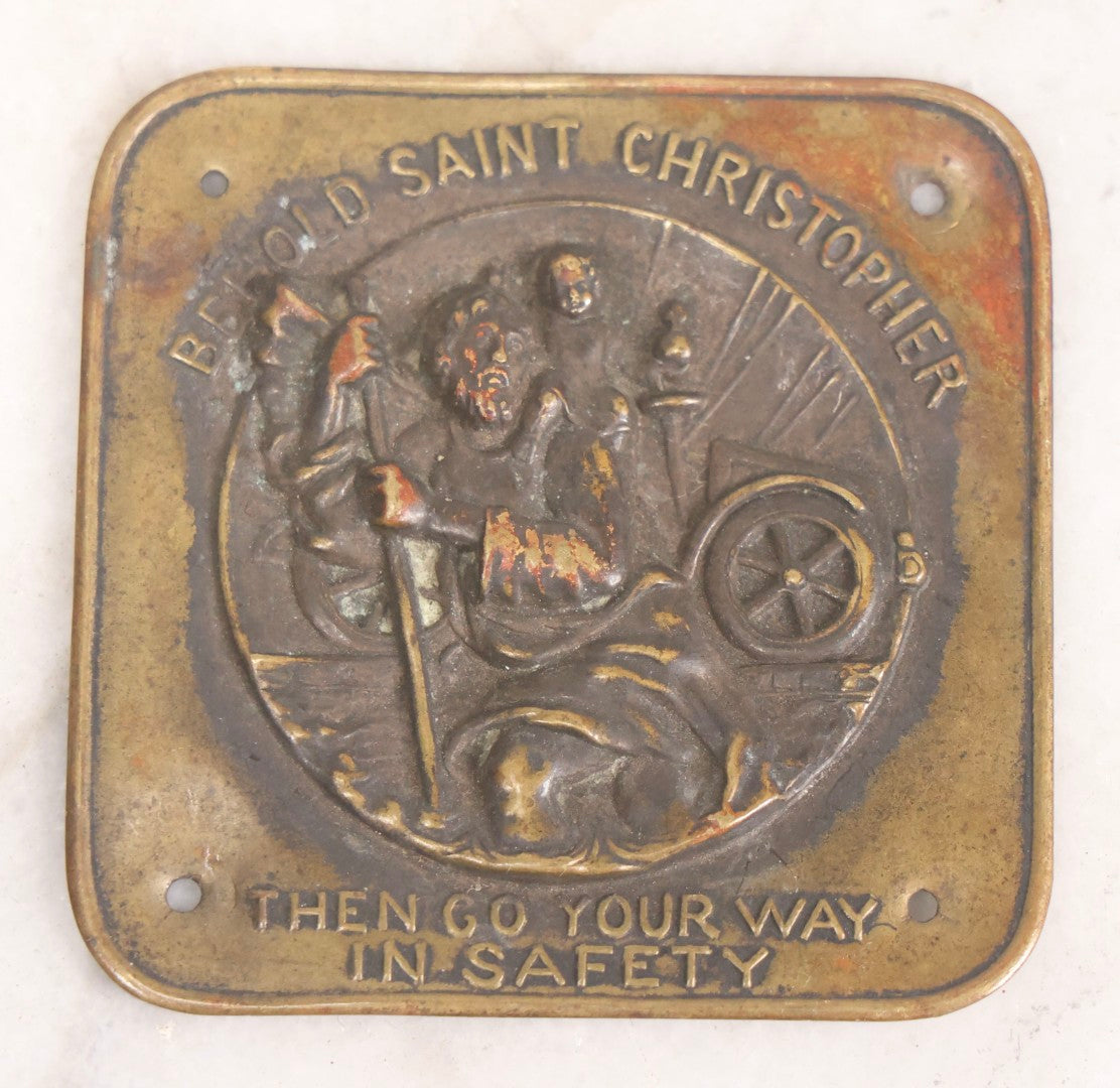 Lot 281 - Grouping Of Four Vintage Metal Badges Including St. Christopher Automobile Safety Badge, I.O.O.F.. Odd Fellows Badge, New Idea Product Tag, And Dog Rabies Tag