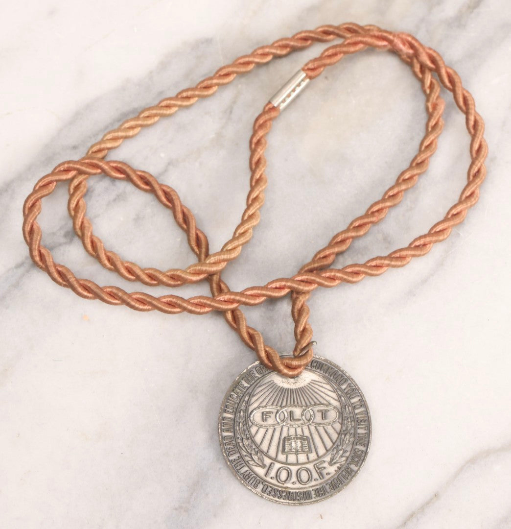 Lot 281 - Grouping Of Four Vintage Metal Badges Including St. Christopher Automobile Safety Badge, I.O.O.F.. Odd Fellows Badge, New Idea Product Tag, And Dog Rabies Tag