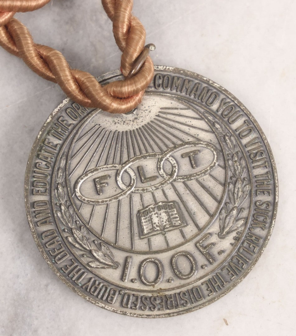 Lot 281 - Grouping Of Four Vintage Metal Badges Including St. Christopher Automobile Safety Badge, I.O.O.F.. Odd Fellows Badge, New Idea Product Tag, And Dog Rabies Tag