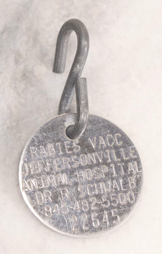 Lot 281 - Grouping Of Four Vintage Metal Badges Including St. Christopher Automobile Safety Badge, I.O.O.F.. Odd Fellows Badge, New Idea Product Tag, And Dog Rabies Tag