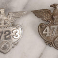 Lot 284 - Pair Of Vintage Ohio Police Patrolman's Standard Wreath Badges With Eagle Design, Numbered 4764 And 7723