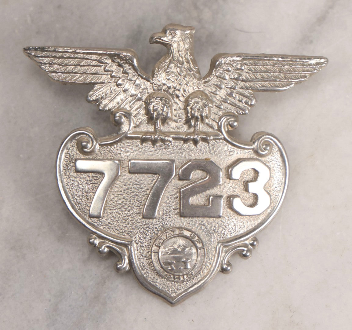 Lot 284 - Pair Of Vintage Ohio Police Patrolman's Standard Wreath Badges With Eagle Design, Numbered 4764 And 7723