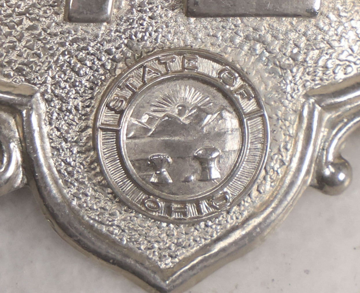 Lot 284 - Pair Of Vintage Ohio Police Patrolman's Standard Wreath Badges With Eagle Design, Numbered 4764 And 7723