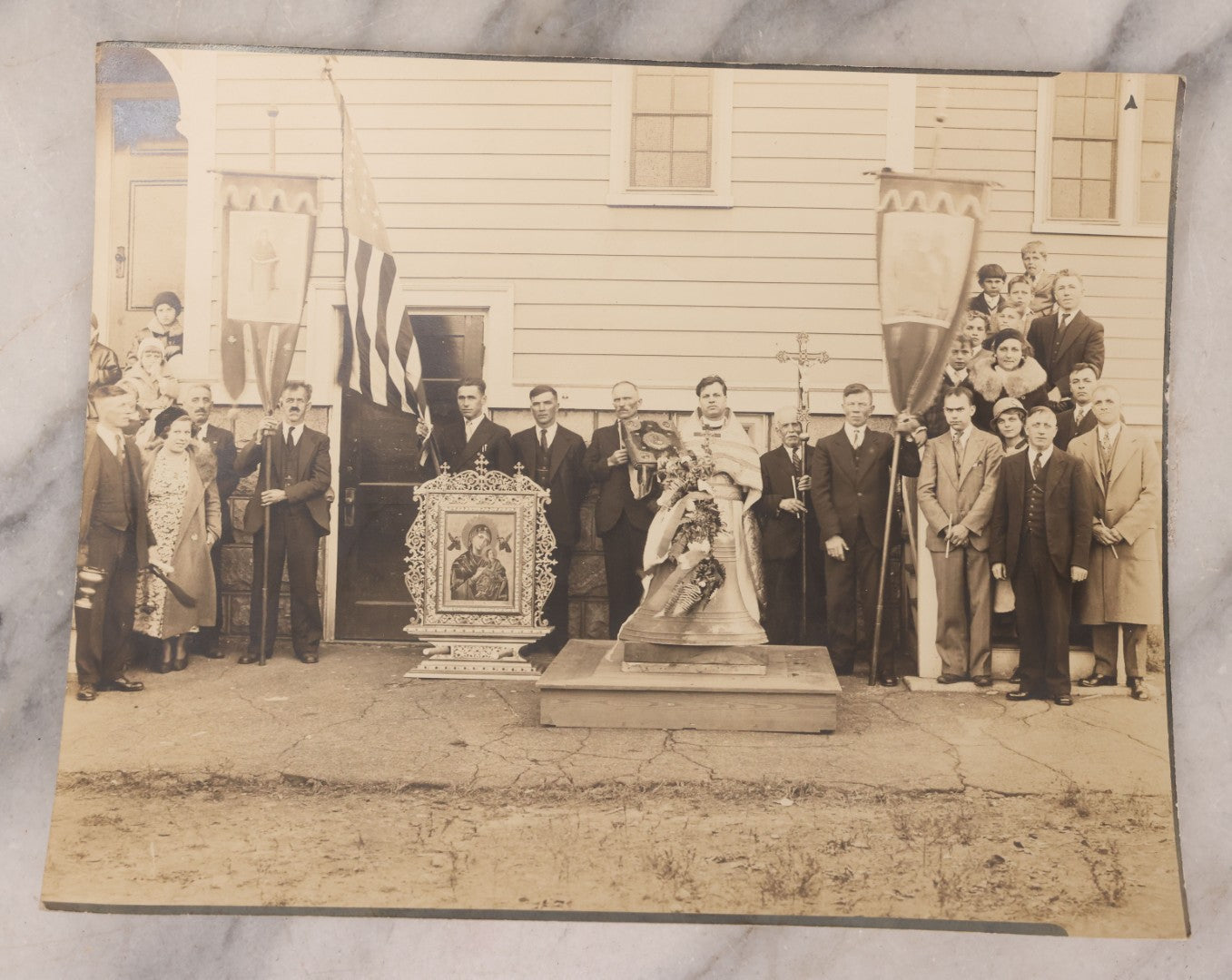 Lot 293 - Antique Unmounted Photograph Depicting Priest And Churchgoers Holding Banners Before Large Icon And Bell, Circa 1914, Handwritten Note On Verso Identifies Wasyl Pilch Holding Gospel, Founder Of St. Peter & Paul Church