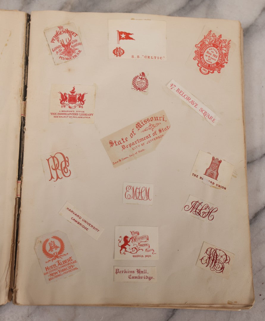 Lot 294 - Antique Scrapbook With Clipped Logos, Seals, And Institutional Names From Colleges, Hotels, Clubs, Banks, Government Offices, And More, Arranged By Color Throughout 20+ Pages, Marbled Cover Boards