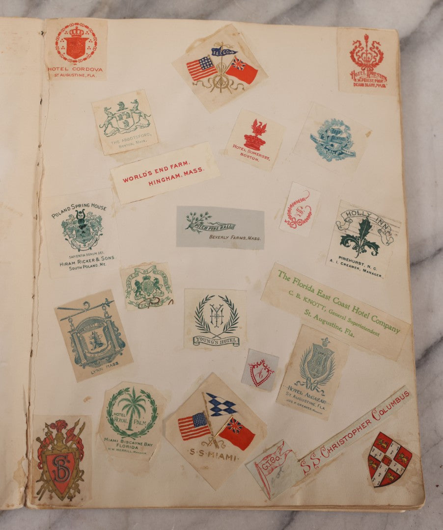 Lot 294 - Antique Scrapbook With Clipped Logos, Seals, And Institutional Names From Colleges, Hotels, Clubs, Banks, Government Offices, And More, Arranged By Color Throughout 20+ Pages, Marbled Cover Boards