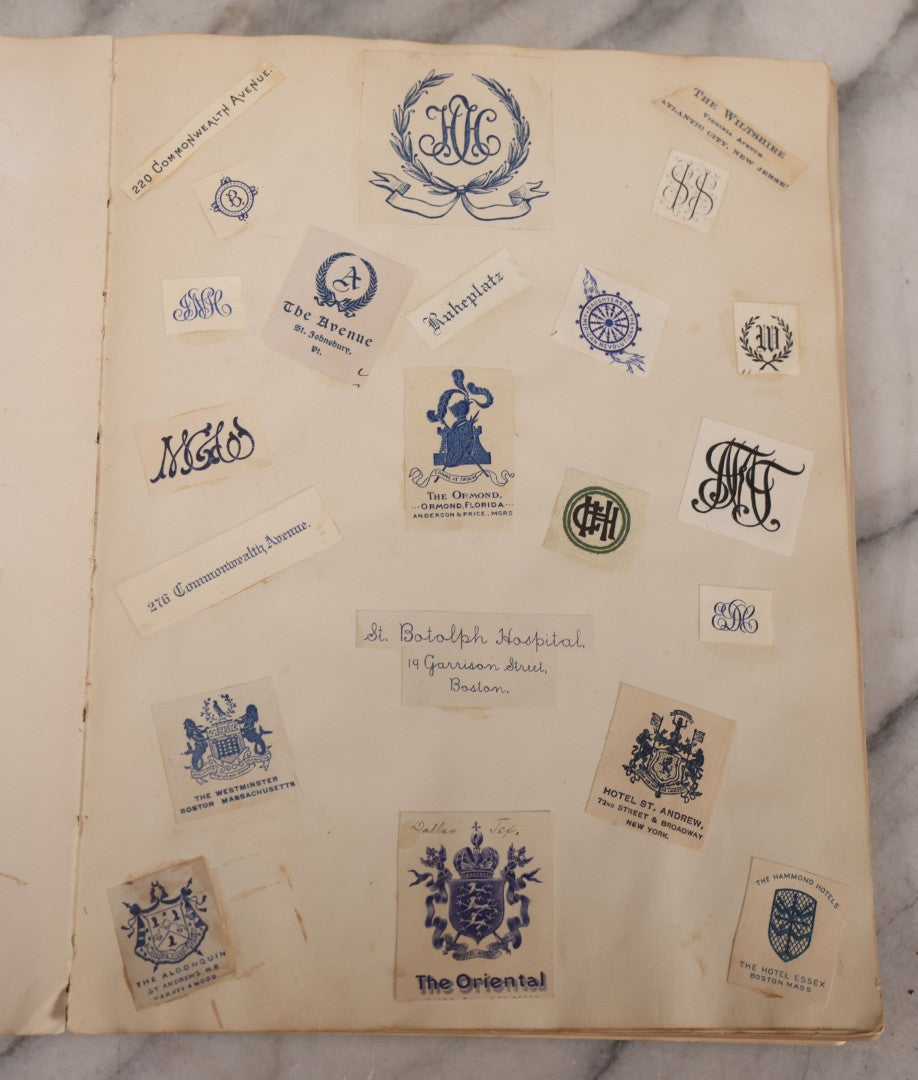 Lot 294 - Antique Scrapbook With Clipped Logos, Seals, And Institutional Names From Colleges, Hotels, Clubs, Banks, Government Offices, And More, Arranged By Color Throughout 20+ Pages, Marbled Cover Boards