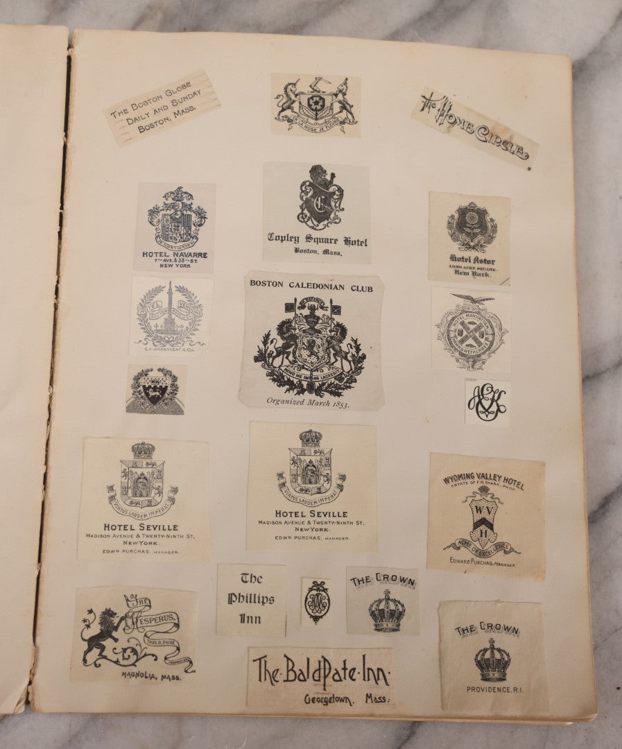 Lot 294 - Antique Scrapbook With Clipped Logos, Seals, And Institutional Names From Colleges, Hotels, Clubs, Banks, Government Offices, And More, Arranged By Color Throughout 20+ Pages, Marbled Cover Boards