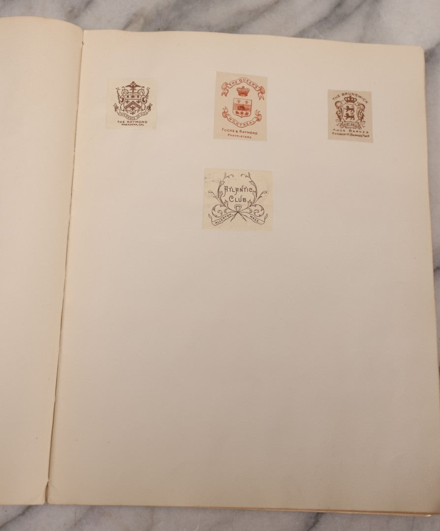 Lot 294 - Antique Scrapbook With Clipped Logos, Seals, And Institutional Names From Colleges, Hotels, Clubs, Banks, Government Offices, And More, Arranged By Color Throughout 20+ Pages, Marbled Cover Boards
