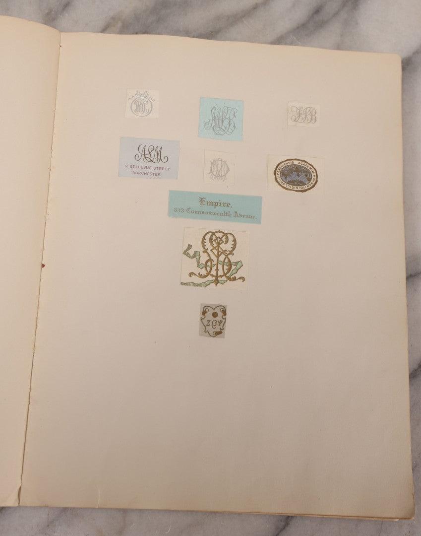 Lot 294 - Antique Scrapbook With Clipped Logos, Seals, And Institutional Names From Colleges, Hotels, Clubs, Banks, Government Offices, And More, Arranged By Color Throughout 20+ Pages, Marbled Cover Boards