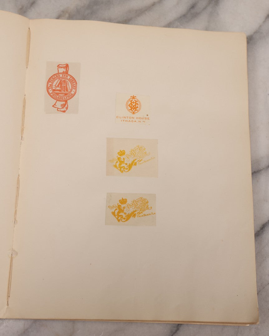 Lot 294 - Antique Scrapbook With Clipped Logos, Seals, And Institutional Names From Colleges, Hotels, Clubs, Banks, Government Offices, And More, Arranged By Color Throughout 20+ Pages, Marbled Cover Boards