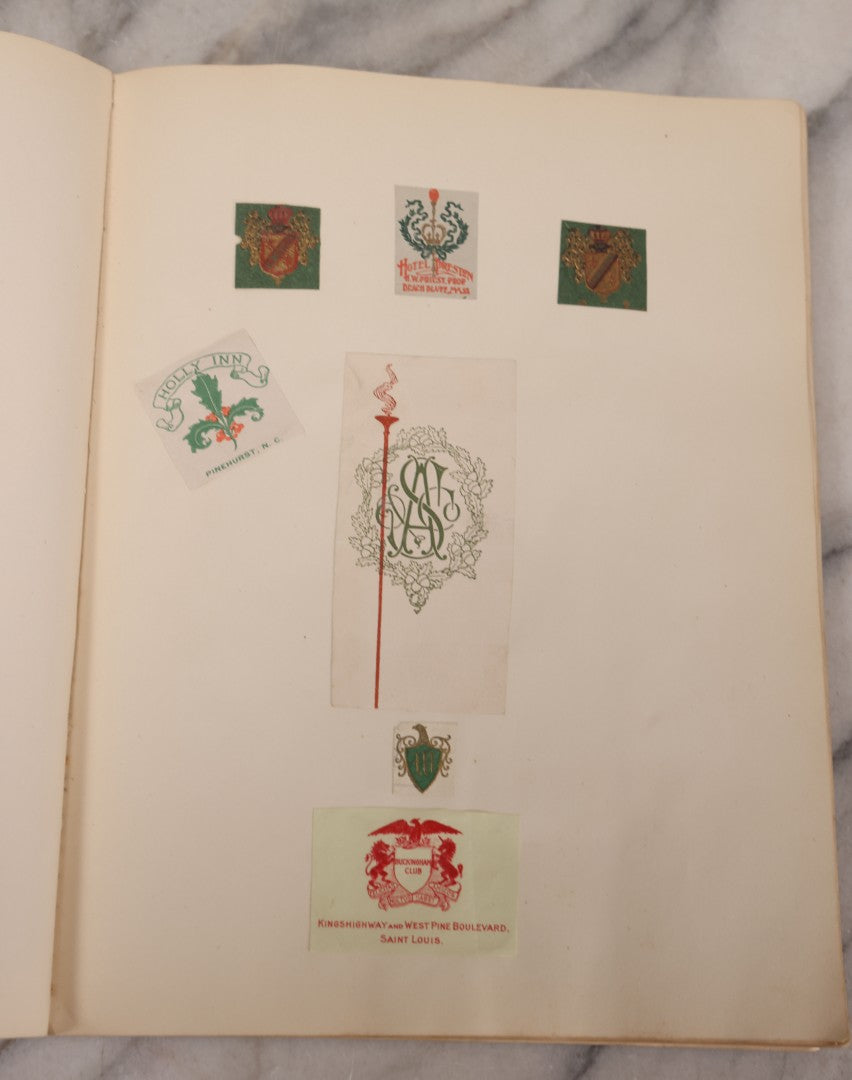 Lot 294 - Antique Scrapbook With Clipped Logos, Seals, And Institutional Names From Colleges, Hotels, Clubs, Banks, Government Offices, And More, Arranged By Color Throughout 20+ Pages, Marbled Cover Boards