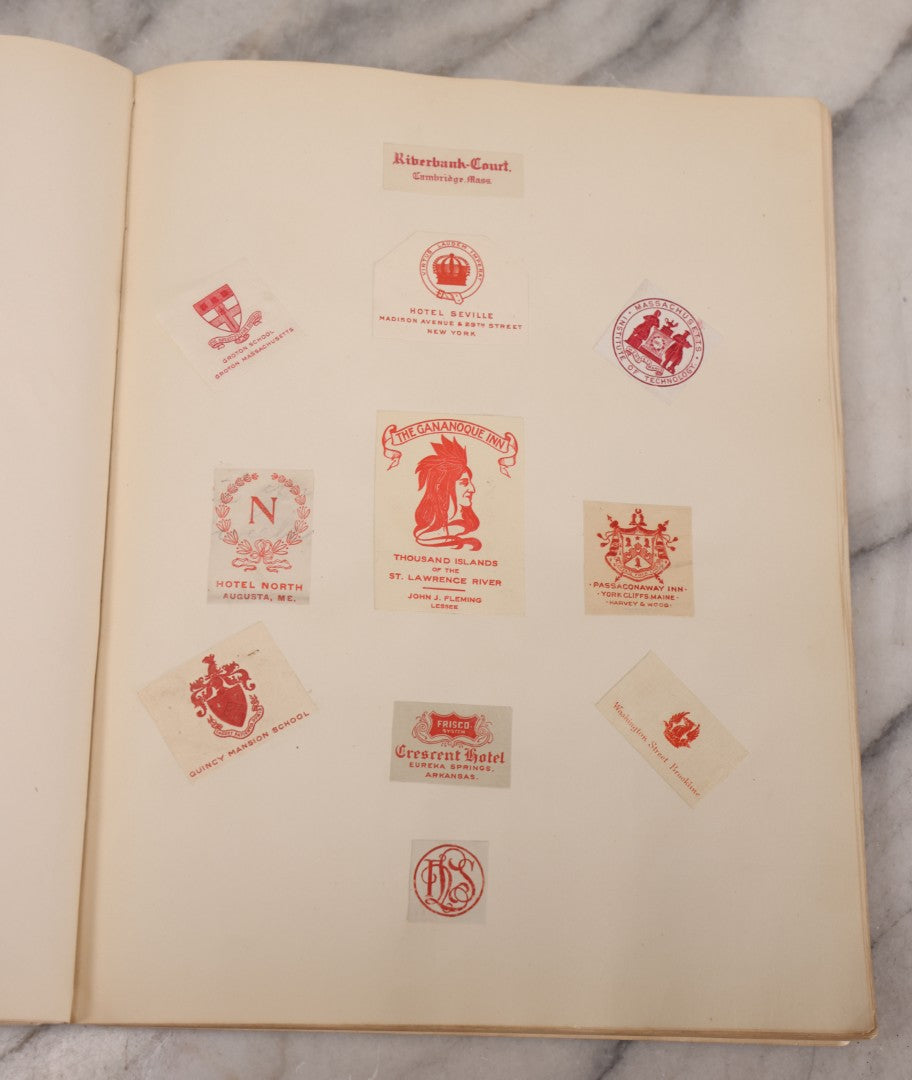 Lot 294 - Antique Scrapbook With Clipped Logos, Seals, And Institutional Names From Colleges, Hotels, Clubs, Banks, Government Offices, And More, Arranged By Color Throughout 20+ Pages, Marbled Cover Boards