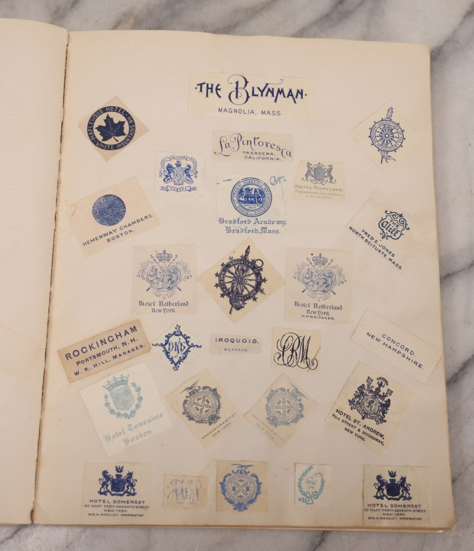 Lot 294 - Antique Scrapbook With Clipped Logos, Seals, And Institutional Names From Colleges, Hotels, Clubs, Banks, Government Offices, And More, Arranged By Color Throughout 20+ Pages, Marbled Cover Boards