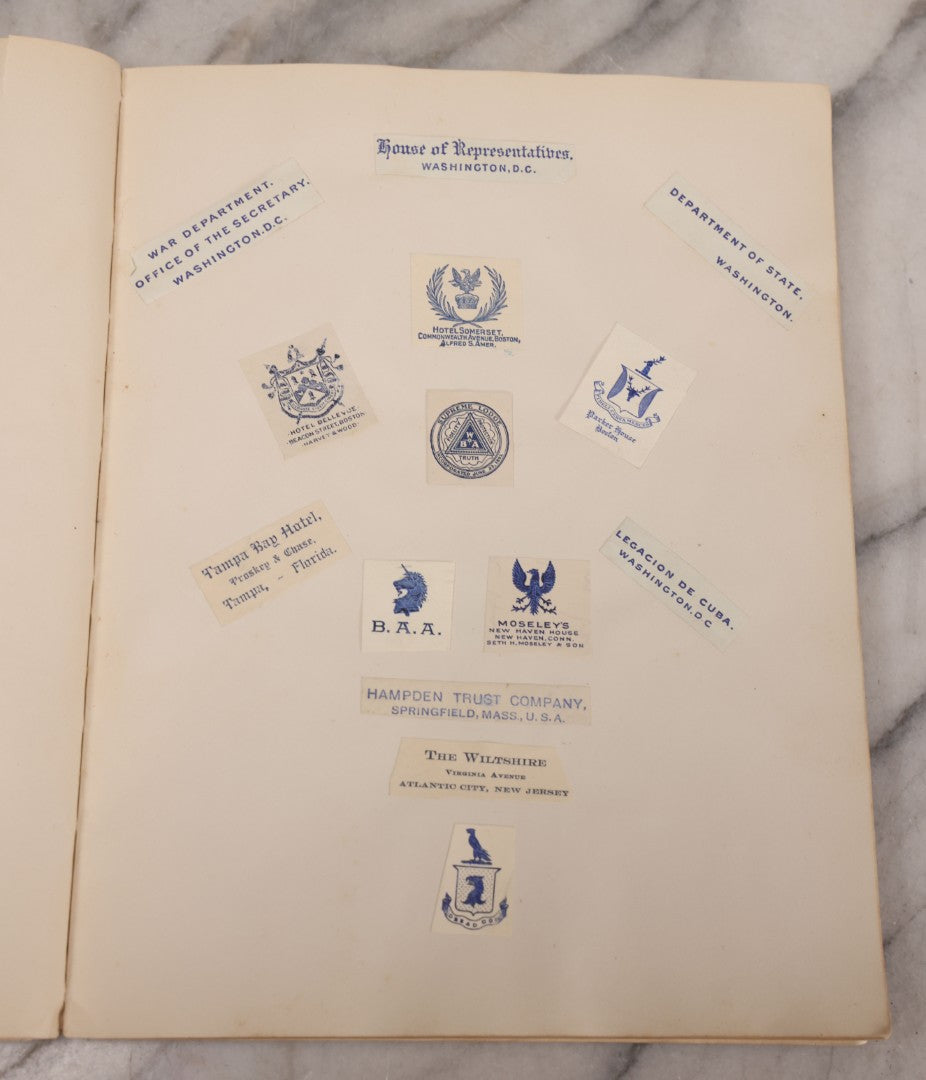 Lot 294 - Antique Scrapbook With Clipped Logos, Seals, And Institutional Names From Colleges, Hotels, Clubs, Banks, Government Offices, And More, Arranged By Color Throughout 20+ Pages, Marbled Cover Boards